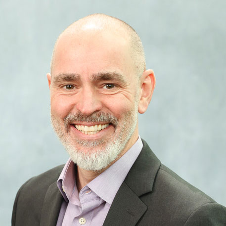 Headshot of Josh Kliner, Chief Information Officer at Storilly. Josh is wearing a button-down shirt with a jacket, without a tie.